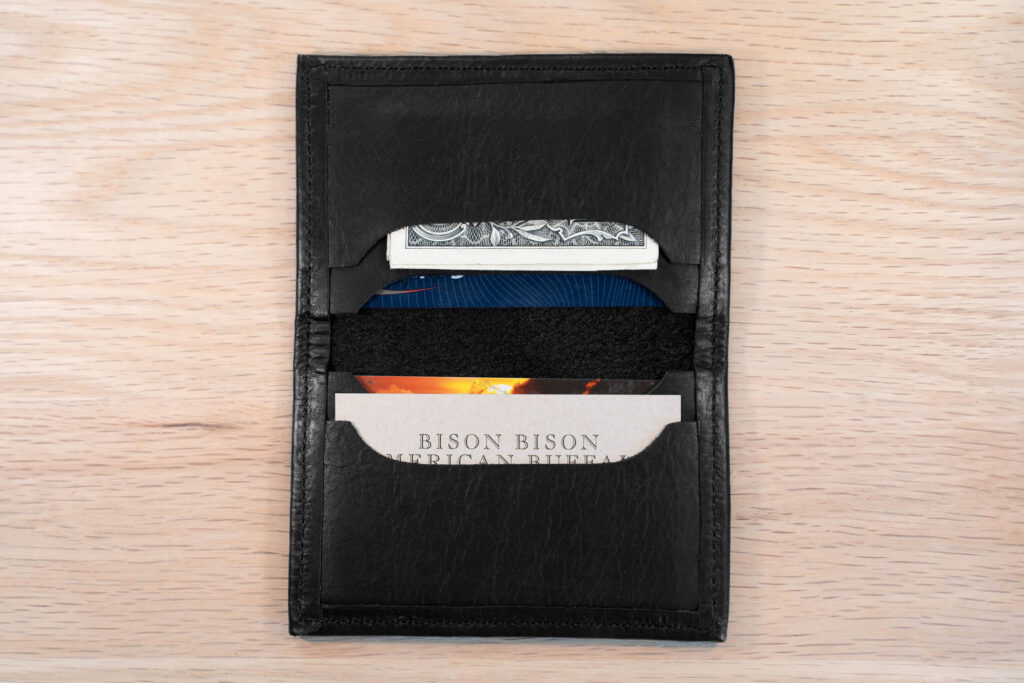 Four card pockets on the inside of the black bifold leather card holder
