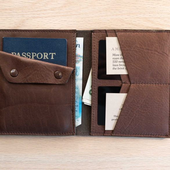 Inside of brown leather passport wallet showing four card slots, two bill slots, a passport slot, and coin pouch.