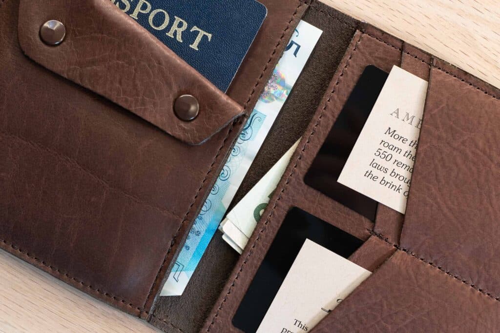 Two Bill Slots Inside With Folded Us Dollars And Unfolded British Pound Bills