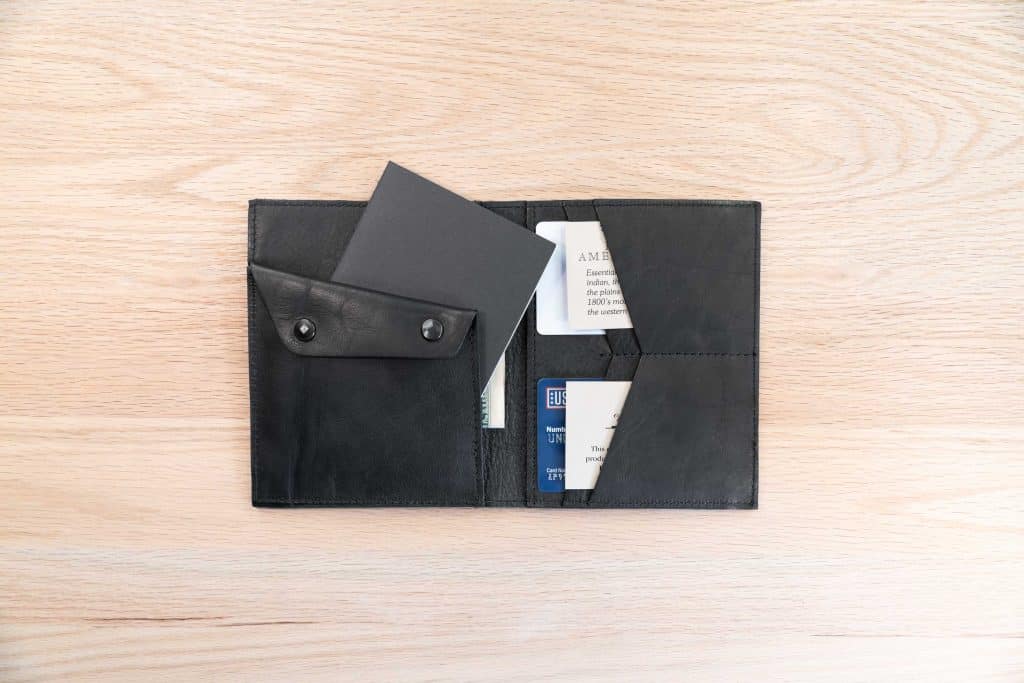 The field note wallet has a slot for your small field journal behind the coin pouch.