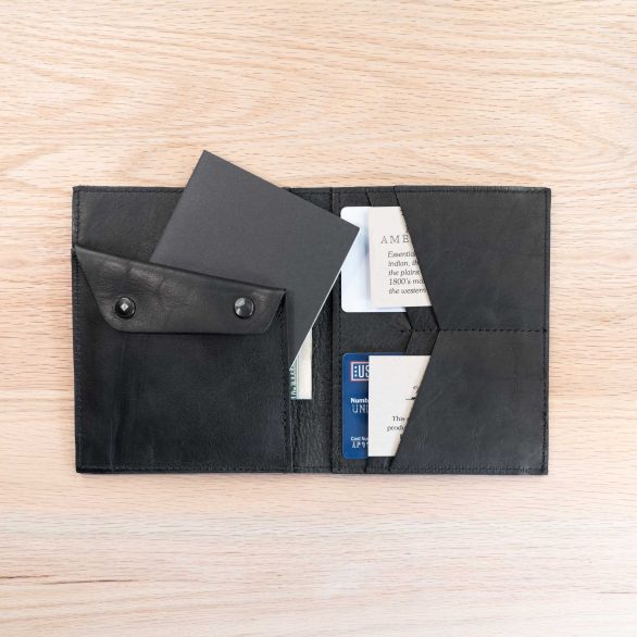 The field note wallet has a slot for your small field journal behind the coin pouch.