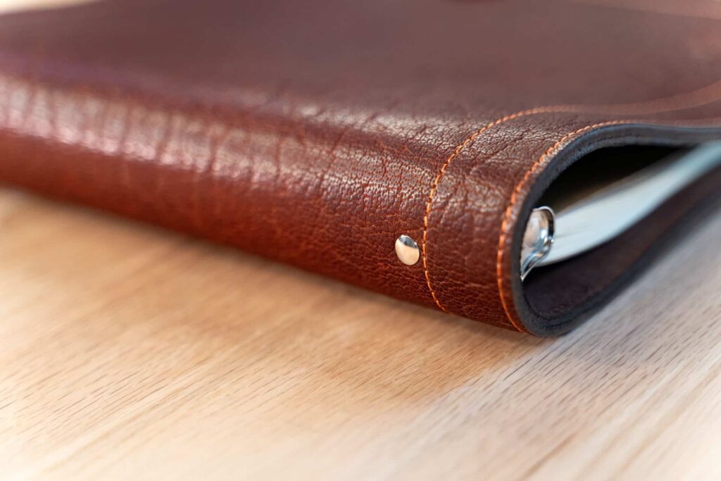 Metal Rivets hold the 3 ring binder to the leather.