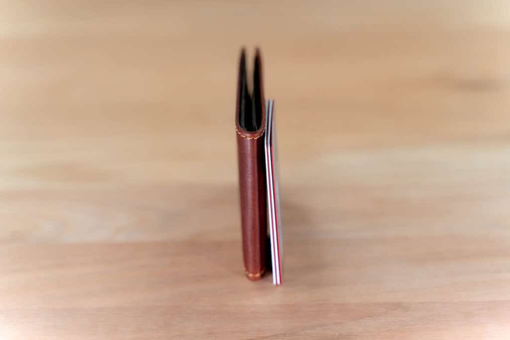 Thin Bifold Leather Wallet Next To A Stack Of 3 Credit Cards So You Can See How Thin It Is
