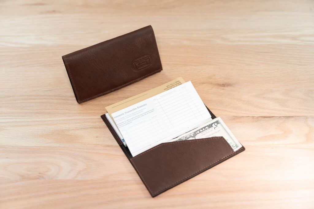 Mens Leather Checkbook Cover Holding Us Dollar Bills