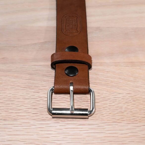 A 1.5 inch wide whiskey tan full grain leather belt with steel roller buckle