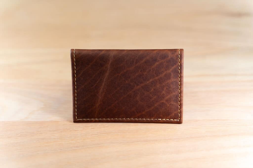 Showing The Full-Grain American Bison Leather Of The American Chestnut Bifold Leather Card Holder With Id