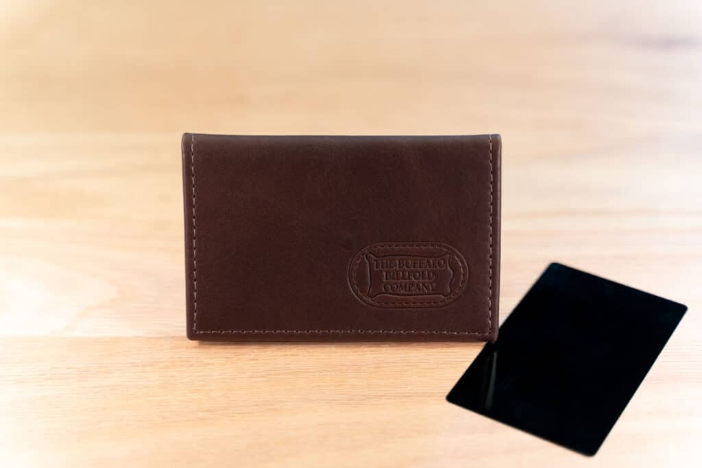 Black Credit Card Next To The Brown Leather Bifold Card Holder