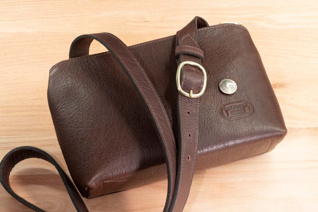 Adjustable Leather Strap Laid Across The Top Of The Brown Southern Prairie Crossbody Leather Purse Adjustable Leather Strap Laid Across The Top Of The Brown Southern Prairie Crossbody Leather Purse