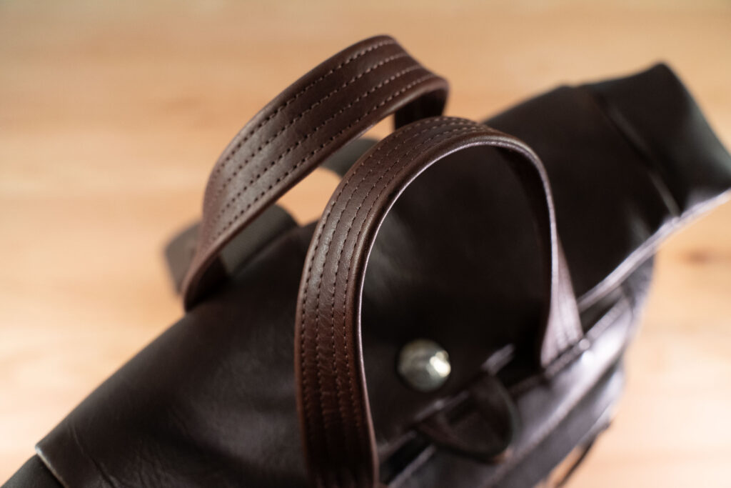 Northbound Backpack Handle Detail Reinforced Leather Handle Detail On Northbound Bison Leather Backpack